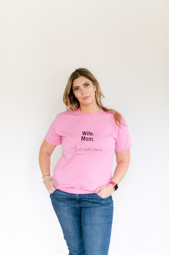 Courtney DuBois Shihabuddin during breast cancer treatment, wearing a pink t-shirt that reads Wife. Mom. Survivor.